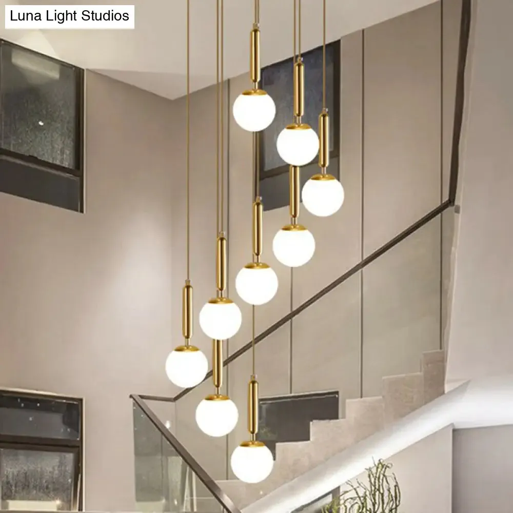 Gold Multi Hanging Stairway Light with Minimalist White Glass Ball Pendant