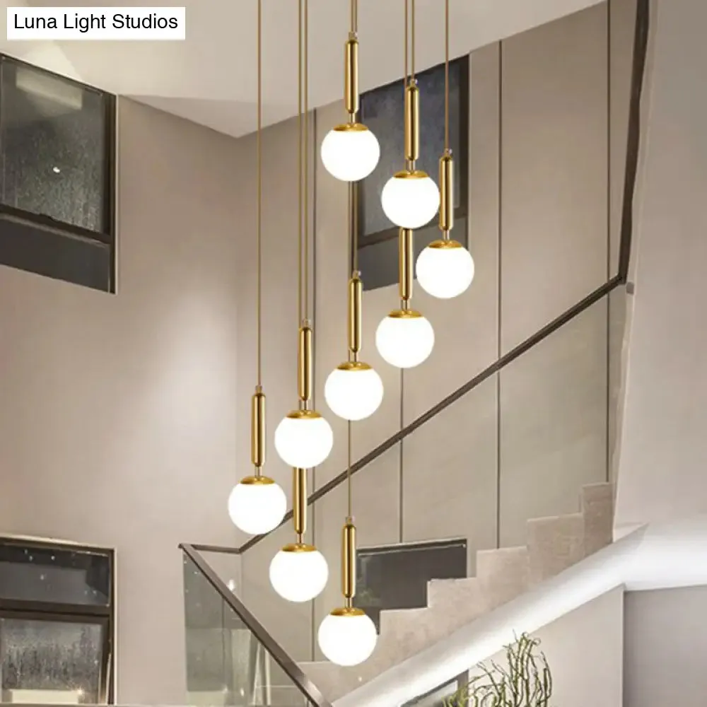 Gold Multi Hanging Stairway Light with Minimalist White Glass Ball Pendant