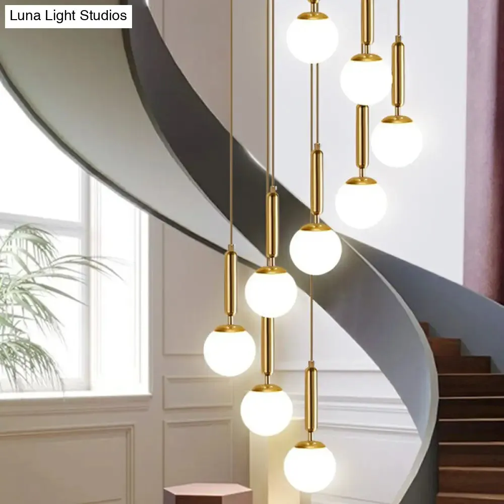Gold Multi Hanging Stairway Light with Minimalist White Glass Ball Pendant