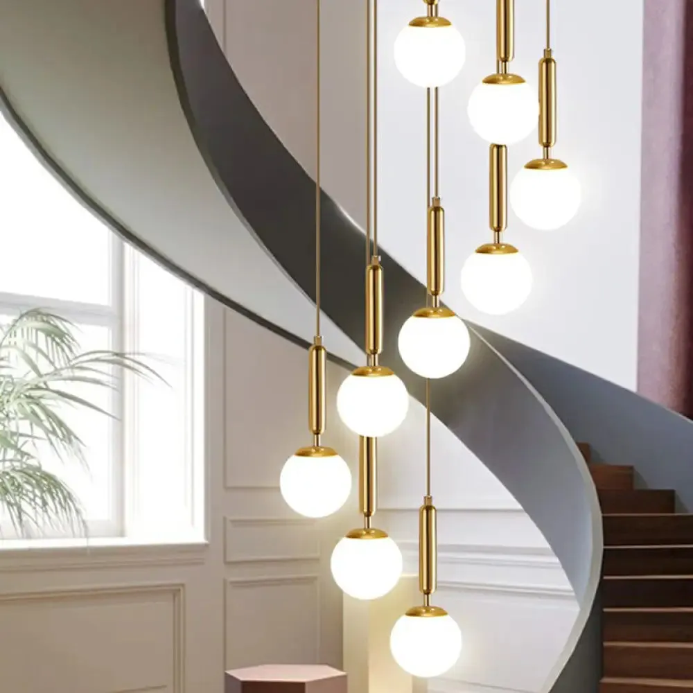 Gold Multi Hanging Stairway Light with Minimalist White Glass Ball Pendant