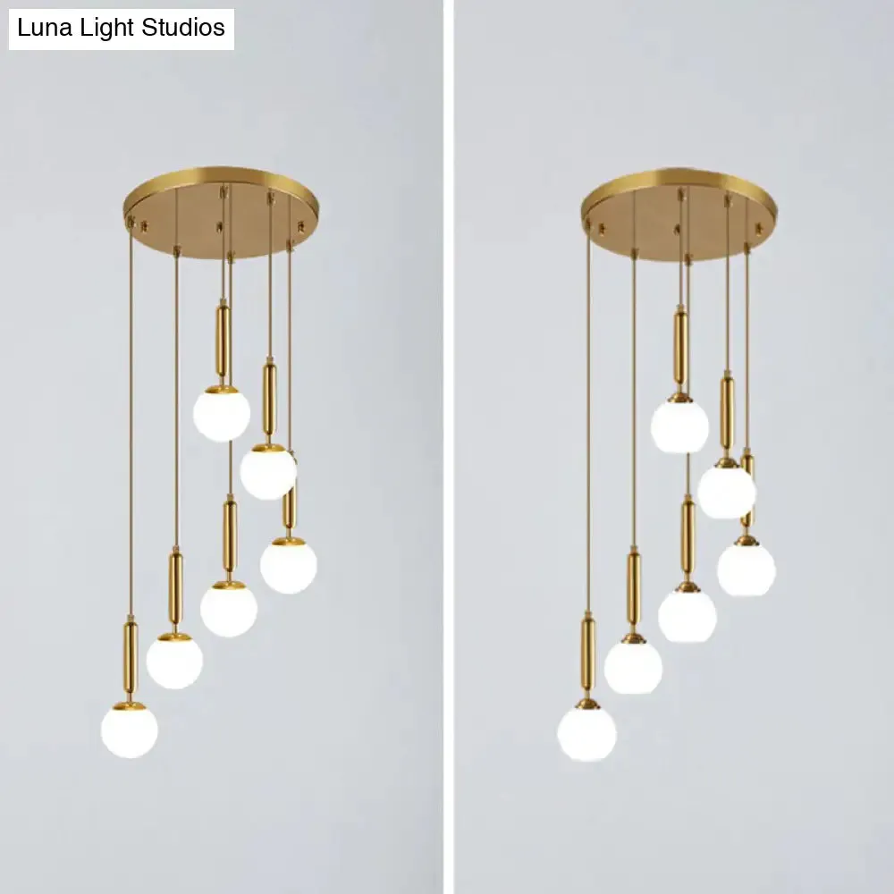 Gold Multi Hanging Stairway Light with Minimalist White Glass Ball Pendant