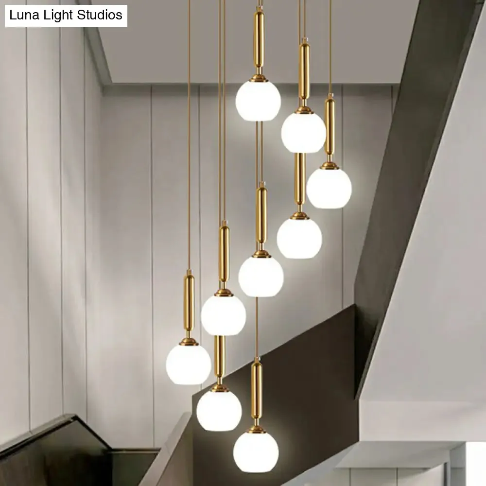 Gold Multi Hanging Stairway Light with Minimalist White Glass Ball Pendant