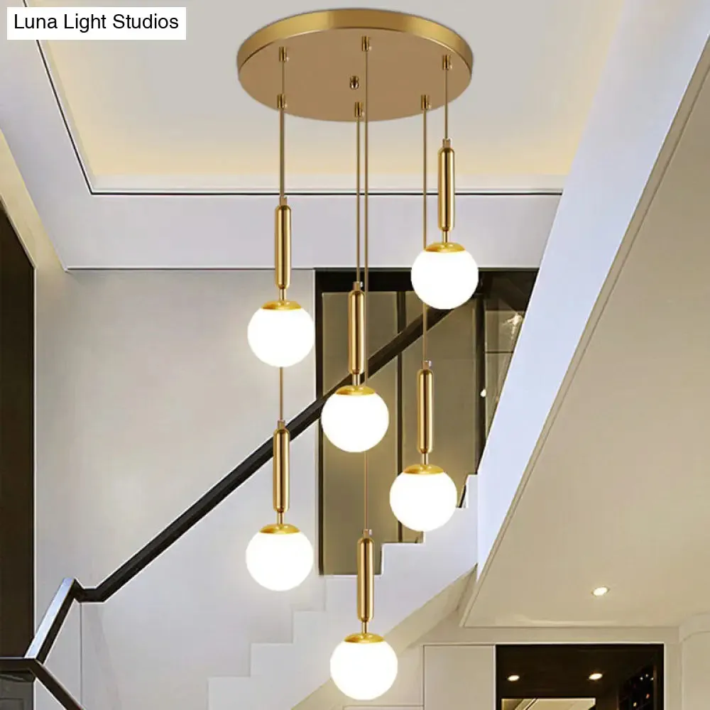 Gold Multi Hanging Stairway Light with Minimalist White Glass Ball Pendant